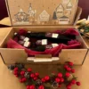Coffret cadeau de Noël artisanal contenant plusieurs bouteilles de vinaigre et balsamique VB, présentées dans un emballage festif décoré de motifs hivernaux.